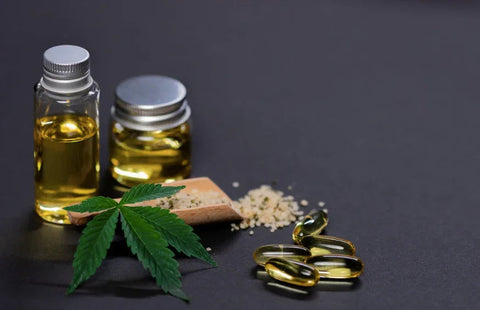 Delta-9 THC hemp oil bottles, softgel capsules, and a cannabis leaf on a dark background