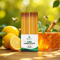 CBD lemon honey sticks with bees, fresh lemons, and honeycomb outdoors